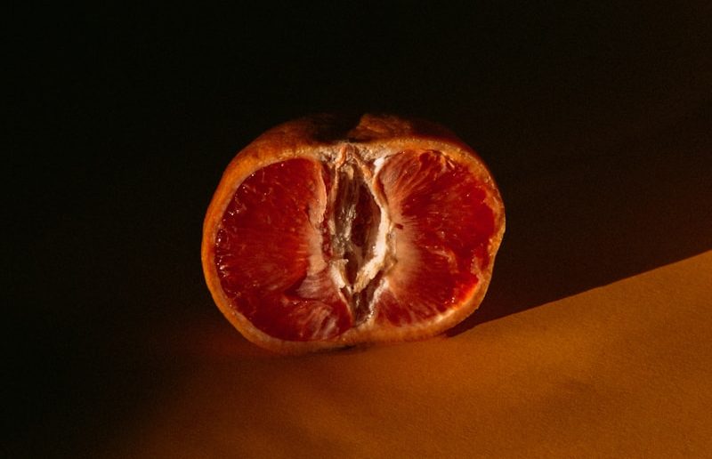 orange fruit on yellow textile