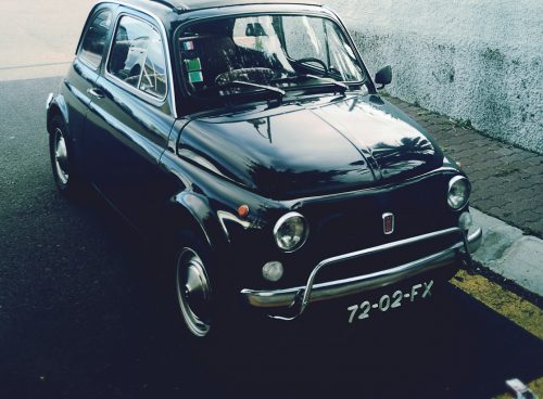 black 3-door hatchback parked near gray concrete wall outdoor