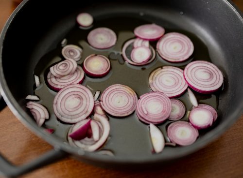 pink and white round candies on black round plate