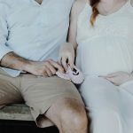 close-up photo of man and woman sitting on bench