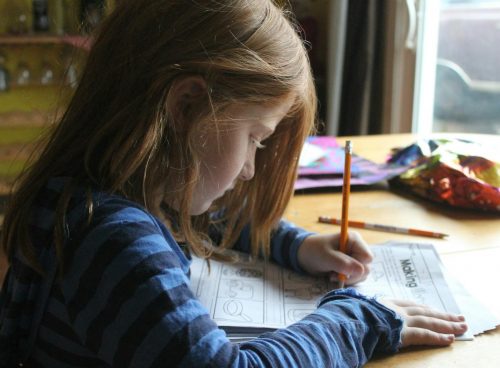 Girl Drawing On Brown Wooden Table