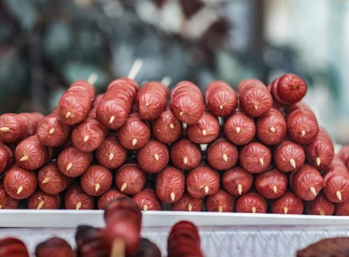 Close-Up Photo of Skewered Sausage on Tray