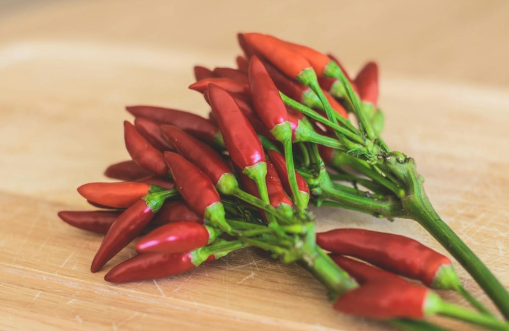 Red Chili Peppers on Brown Wooden Surface