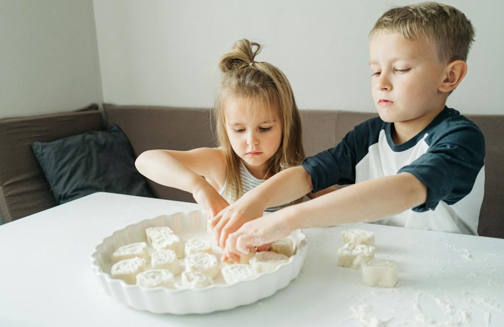 Girl in Blue and White Shirt Sitting Beside Girl in White Shirt