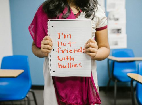 Child Showing a Message Written in a Notebook