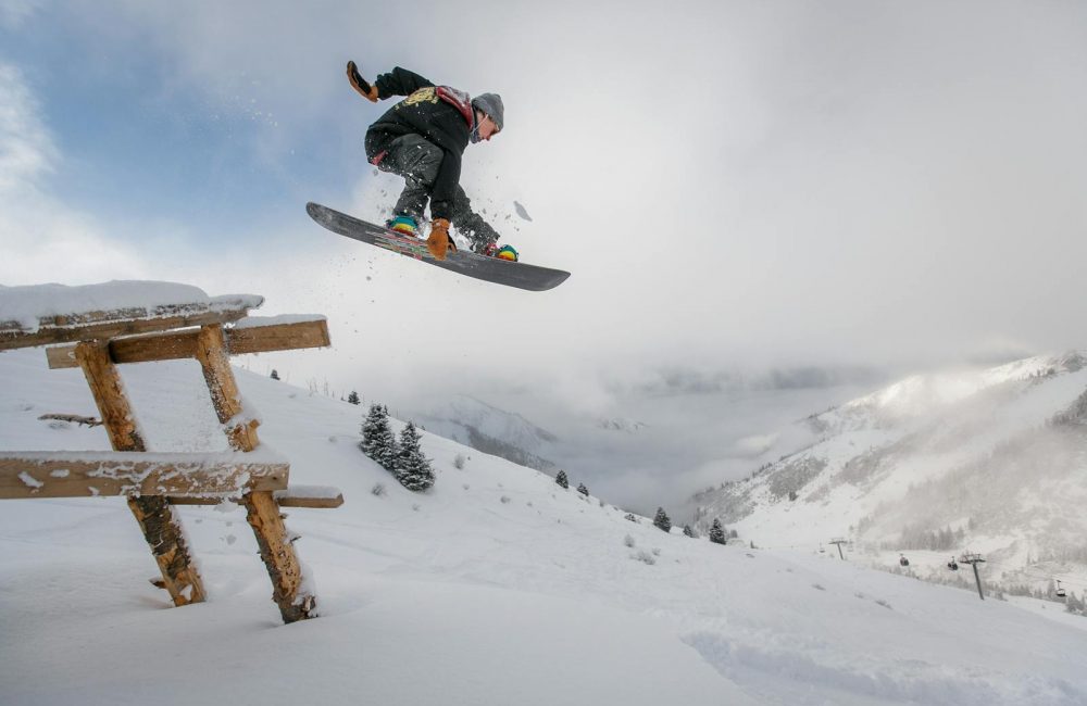 Man in Black Snowboard With Binding Performs a Jump