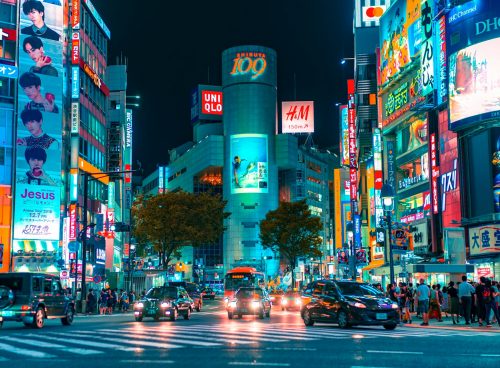 people gathered outside buildings and vehicles