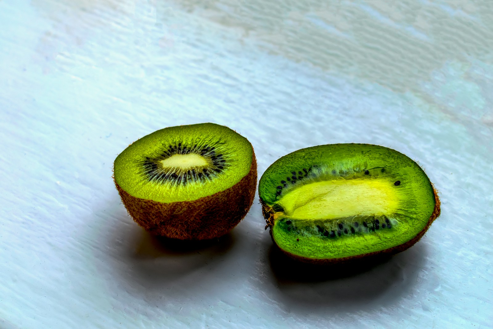 20 Best Foods That Can Help Prevent Insomnia & Enhance Sleep Quality 1 a kiwi cut in half on a white surface