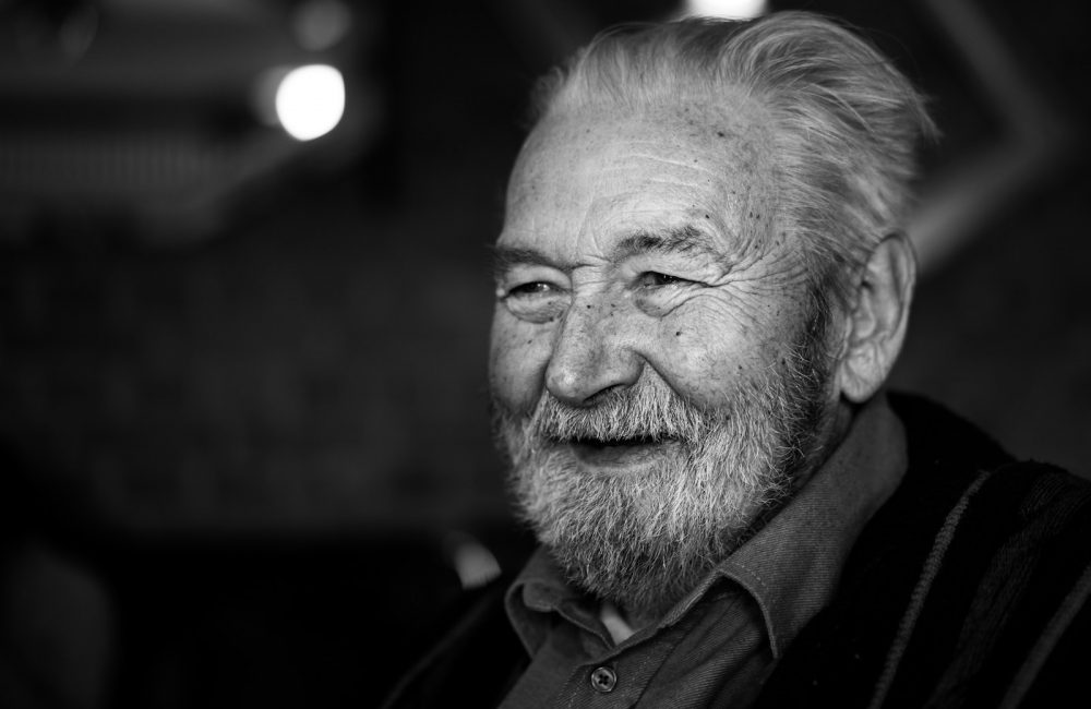 grayscale photography of man wearing button-up collared shirt