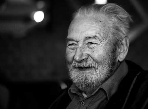 grayscale photography of man wearing button-up collared shirt