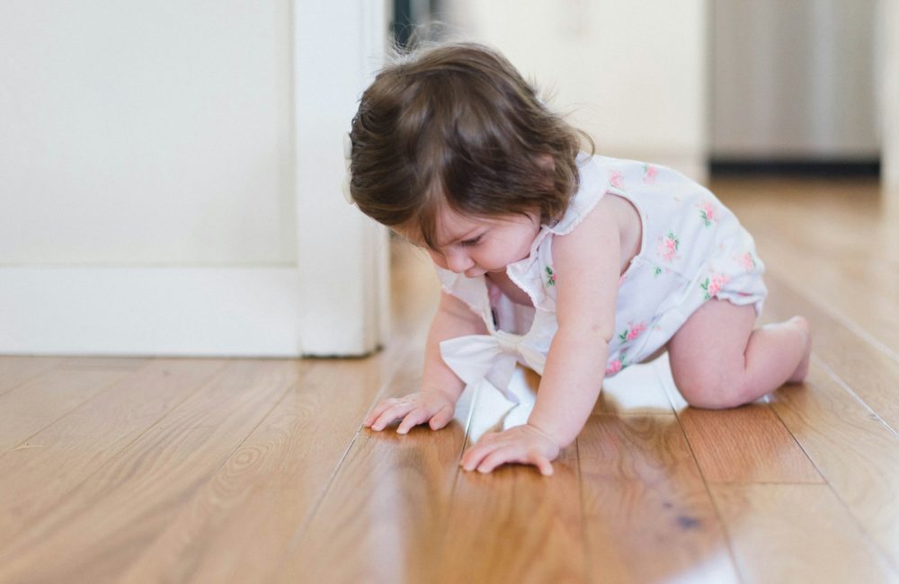 girl crawling on parque floor