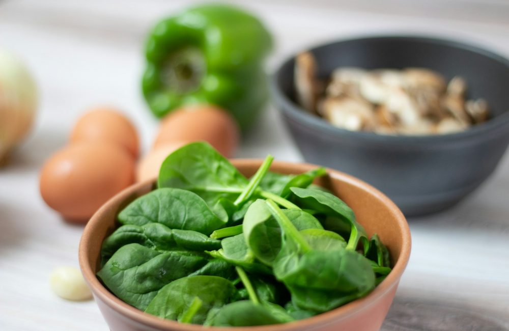 green vegetable on white ceramic bowl