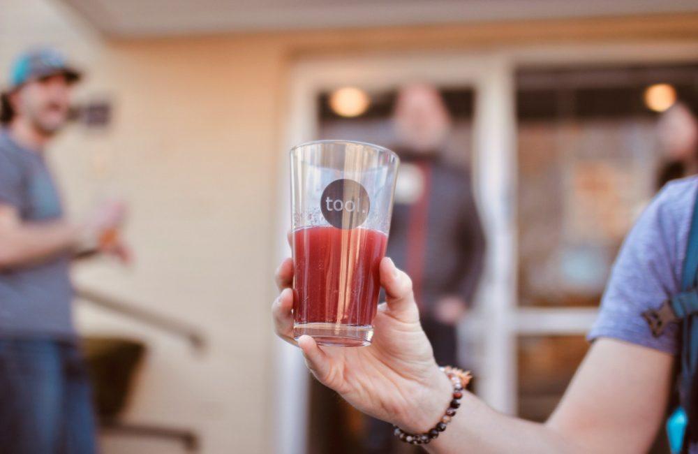 person holding clear drinking glass