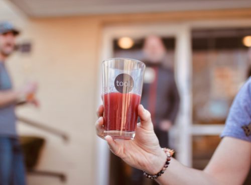 person holding clear drinking glass