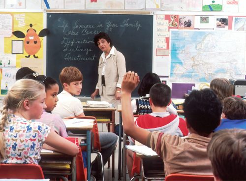 woman standing in front of children