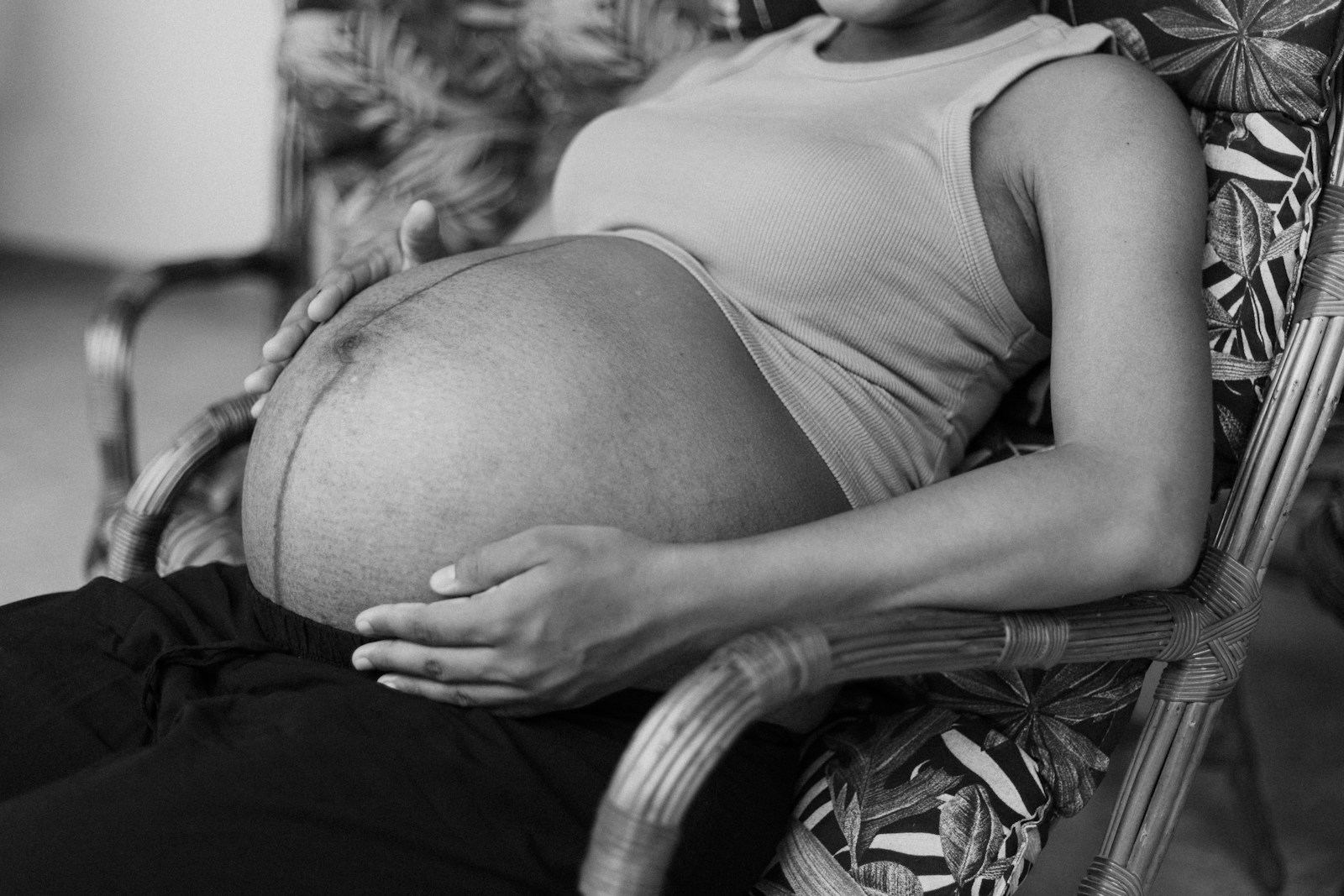 Why is Folate So Important for Pregnant Women 1 a black and white photo of a pregnant woman sitting in a chair