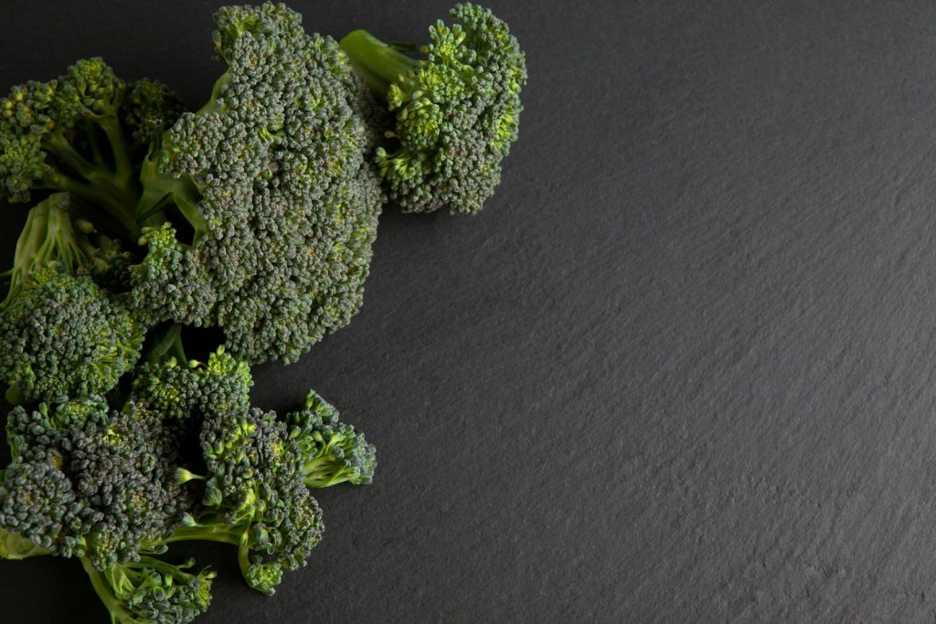 green broccoli on black textile