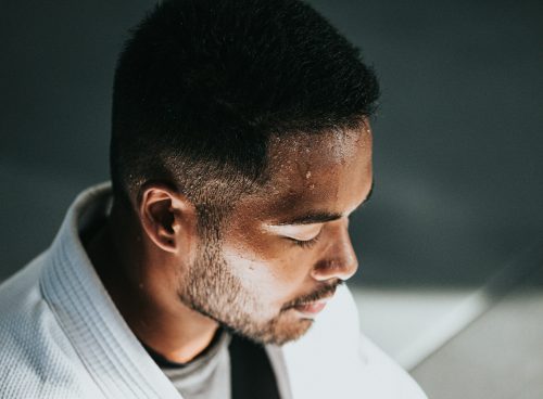 man in white shirt sitting on black chair