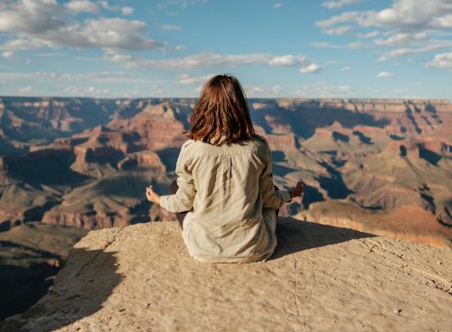 woman sitting on hill