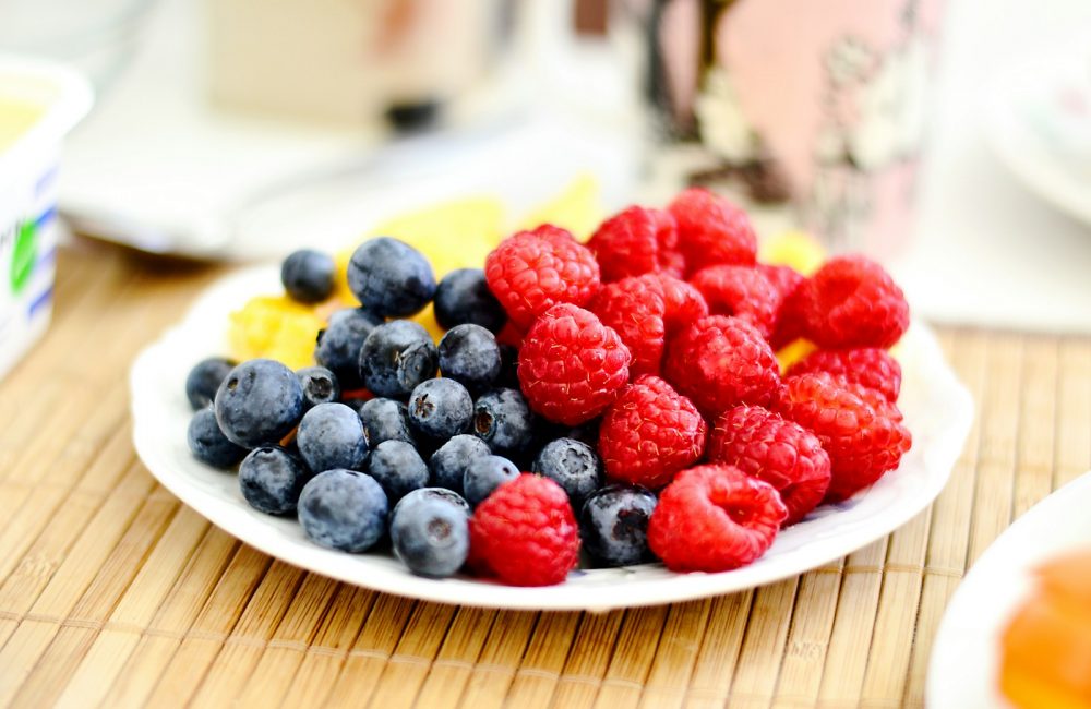 strawberries and blue berries on palte