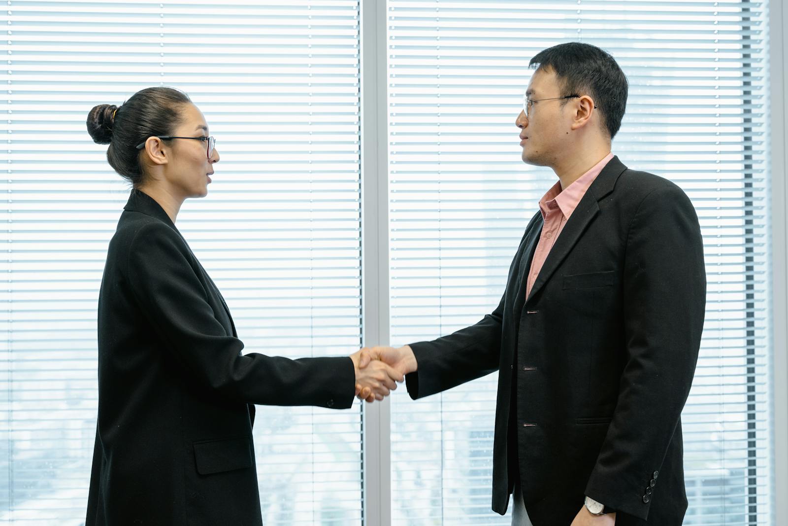 20 Tips to Negotiate a Great Salary at Work 1 Man and Woman Shaking Hands Near the Window