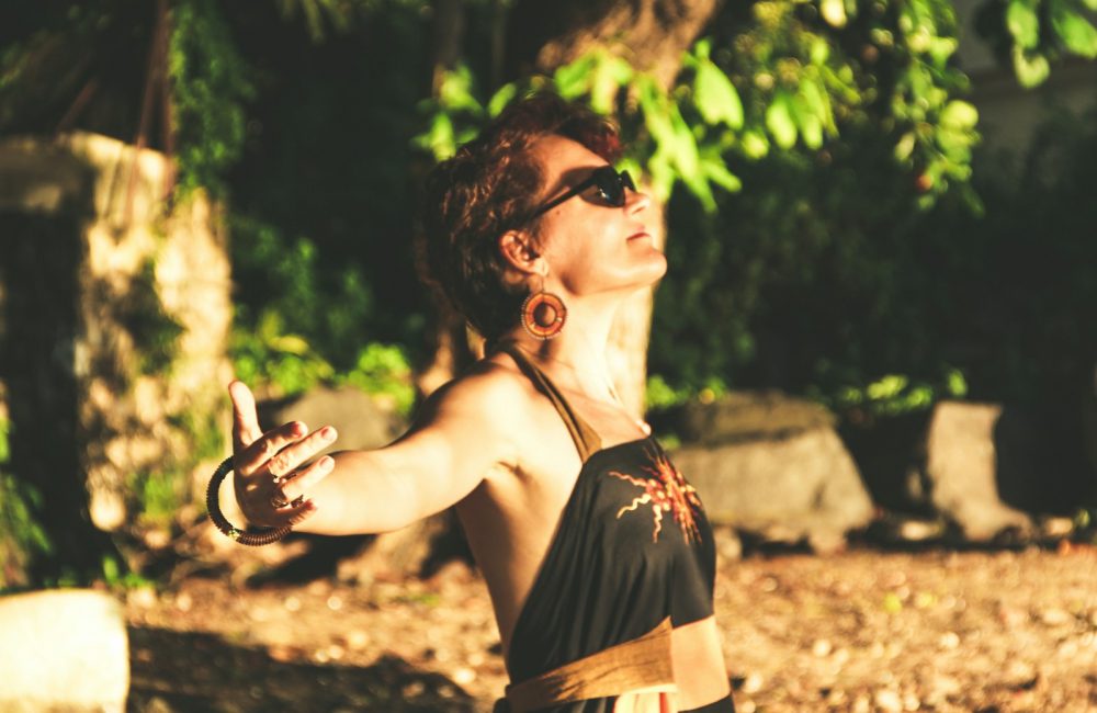 woman in black spaghetti strap top wearing black sunglasses