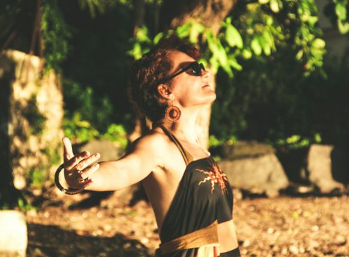woman in black spaghetti strap top wearing black sunglasses