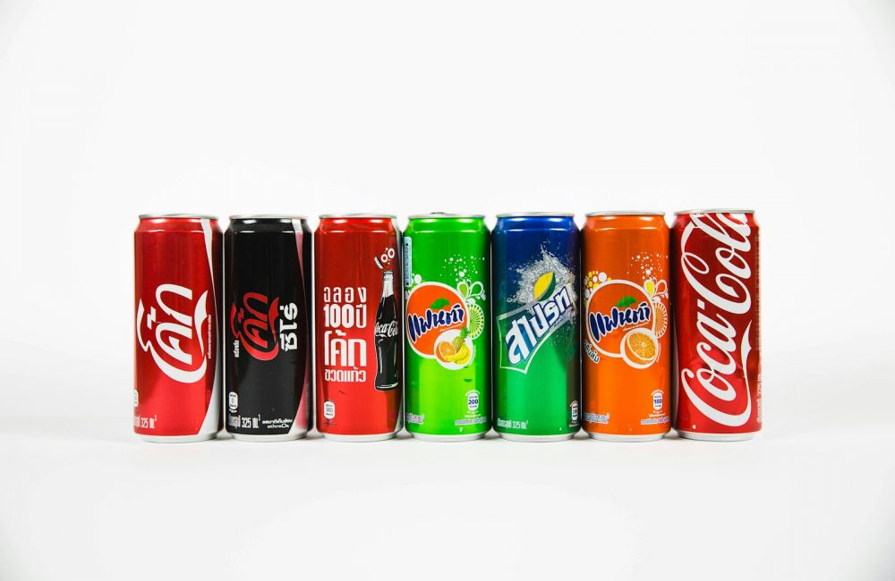 seven assorted-brand soda cans