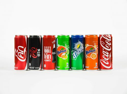 seven assorted-brand soda cans
