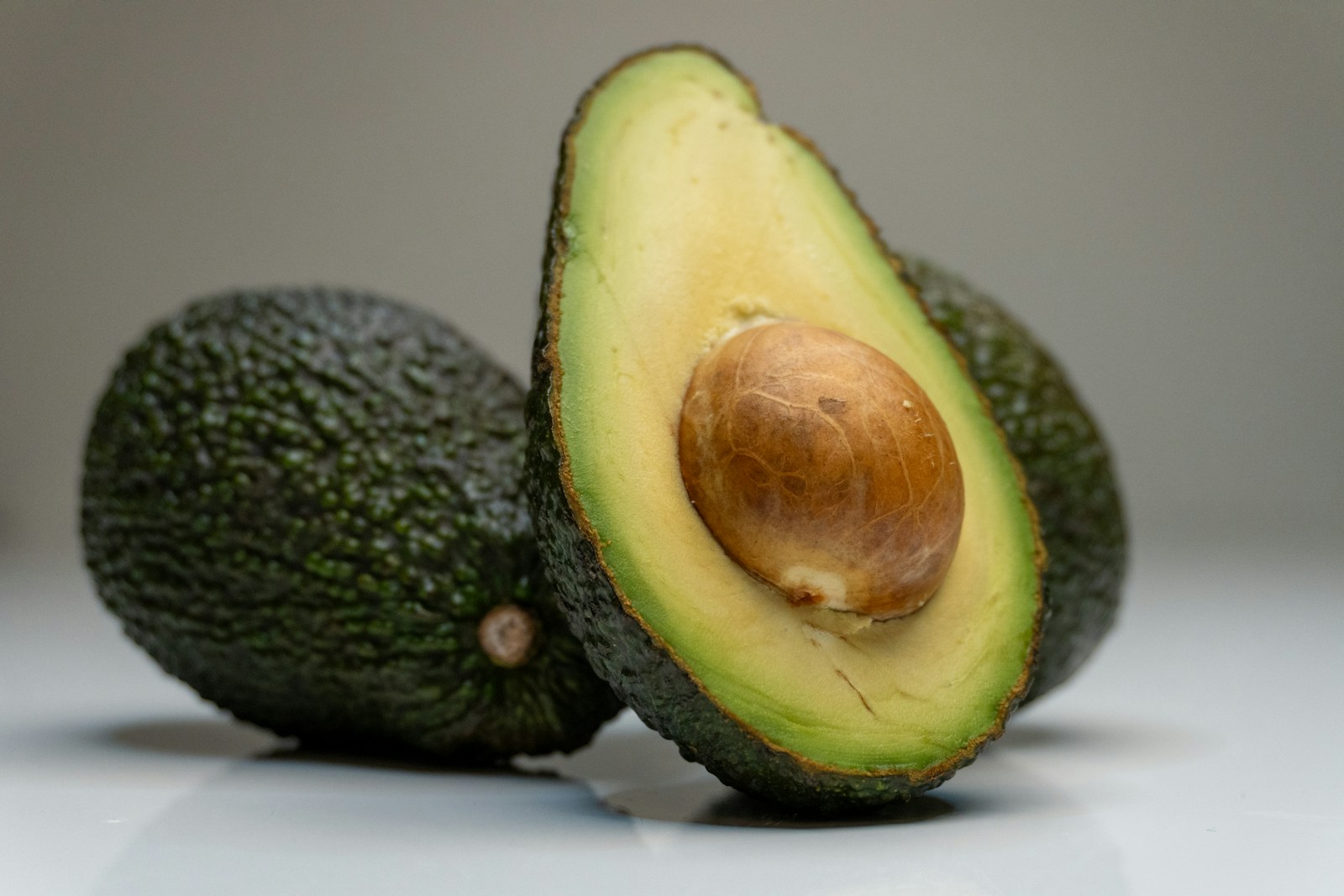 15 Best Foods for Hormonal Balance 1 an avocado cut in half on a table