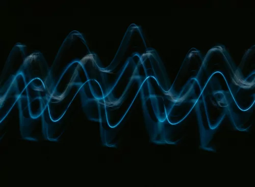 a black background with a blue wave of light